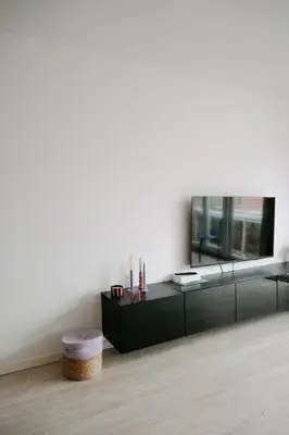 a living room with a black cabinet and a mirror at Casa Congé - Colorful Stay & Free Wine Bottle in Mechelen