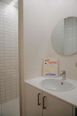 a bathroom with a white sink and a mirror at Casa Congé - Colorful Stay & Free Wine Bottle in Mechelen