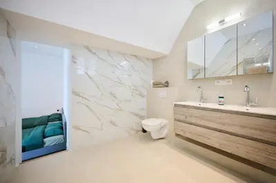 a bathroom with a sink and a toilet and a mirror at Louise City Center in Brussels