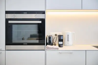 a kitchen with a stove and a microwave at Louise City Center in Brussels