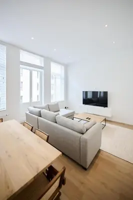 a living room with a couch and a table at Louise City Center in Brussels