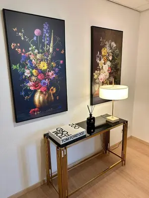 a table in front of a painting of flowers at Grand Place - Prime Location 2 Bedroom Apartment in Brussels
