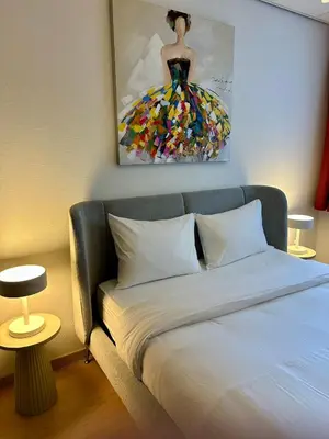 a bedroom with a bed with a painting on the wall at Grand Place - Prime Location 2 Bedroom Apartment in Brussels