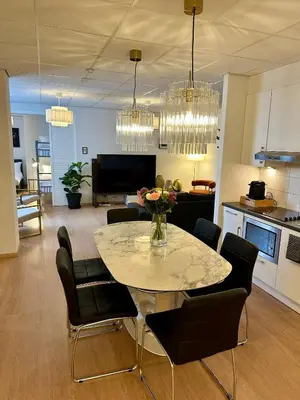 a dining room and living room with a table and chairs at Grand Place - Prime Location 2 Bedroom Apartment in Brussels