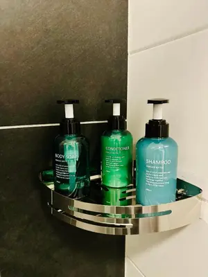 two bottles of soap and shampoo are sitting on a shelf at Grand Place - Prime Location 2 Bedroom Apartment in Brussels