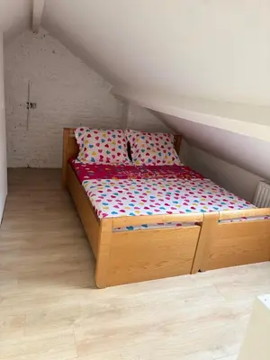 a small bed in a small room in a attic at Marie home in Brussels