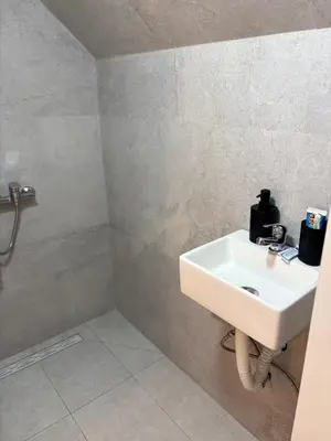 a bathroom with a white sink in a room at Marie home in Brussels
