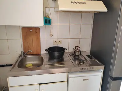 a small kitchen with a sink and a pot on the stove at Belgie in Ghent