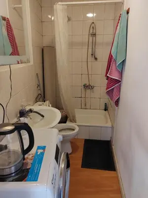 a small bathroom with a toilet and a sink at Belgie in Ghent