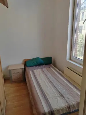 a small bed in a room with a window at Belgie in Ghent
