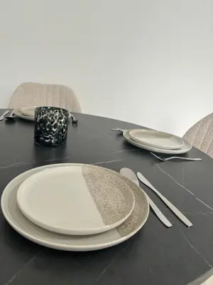 a black table with white plates and silverware on it at Luxury 2BR Apartment Heart of Mechelen in Mechelen