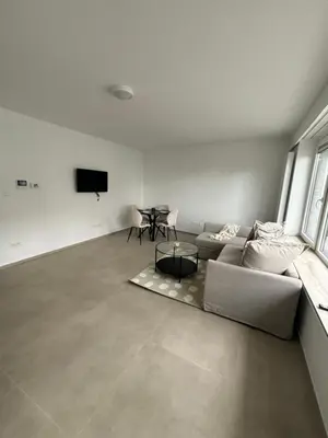 a living room with a couch and a table at Luxury 2BR Apartment Heart of Mechelen in Mechelen