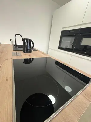 a kitchen with a counter with a stove top oven at Luxury 2BR Apartment Heart of Mechelen in Mechelen
