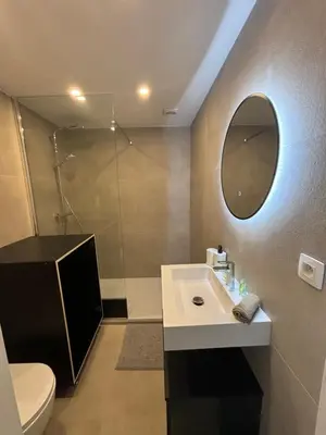 a bathroom with a sink and a shower with a mirror at Luxury 2BR Apartment Heart of Mechelen in Mechelen