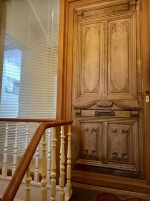 a wooden cabinet in a room with a staircase at Panorama Vue Penthouse in Brussels