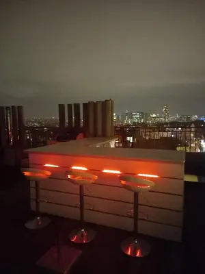 a bar with stools on the top of a building at Panorama Vue Penthouse in Brussels
