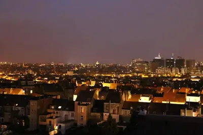 a view of a city at night with buildings at Panorama Vue Penthouse in Brussels