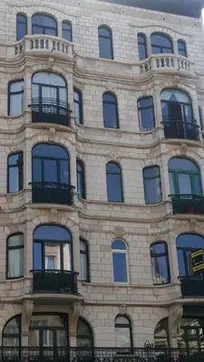 a large brick building with windows and balconies at Panorama Vue Penthouse in Brussels