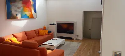 a living room with a couch and a tv at Panorama Vue Penthouse in Brussels
