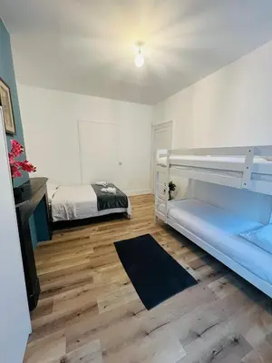 a white room with a bed and a bed sidx sidx sidx at Albergue Bosquet in Brussels