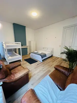 a living room with a bed and a couch at Albergue Bosquet in Brussels