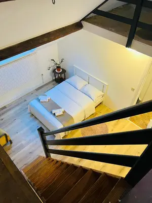 a bedroom with a bed in a room with stairs at Albergue Bosquet in Brussels