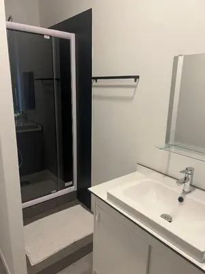 a bathroom with a shower and a sink and a mirror at Albergue Bosquet in Brussels