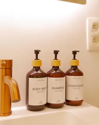 a group of three bottles of soap on a sink at 1 Bdr flat met cozy mezzanine in Antwerp