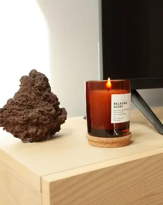 a candle sitting on top of a desk with a tv at 1 Bdr flat met cozy mezzanine in Antwerp