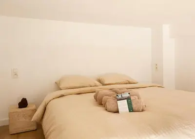 a bedroom with a bed with two stuffed animals on it at 1 Bdr flat met cozy mezzanine in Antwerp