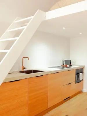 a kitchen with a sink and a staircase at 1 Bdr flat met cozy mezzanine in Antwerp