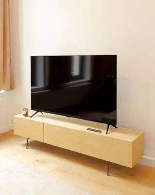 a flat screen tv sitting on a wooden tv stand at 1 Bdr flat met cozy mezzanine in Antwerp