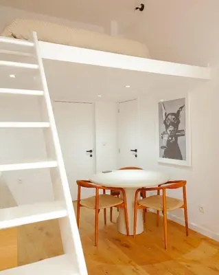 a dining room with a table and a bunk bed at 1 Bdr flat met cozy mezzanine in Antwerp