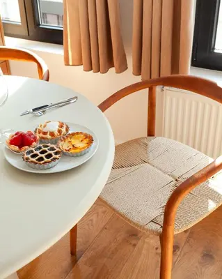 a white table with a plate of food on it at 1 BR Stylish flat with balcony in Antwerp