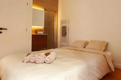 a bedroom with a bed with towels on it at 1 BR Stylish flat with balcony in Antwerp