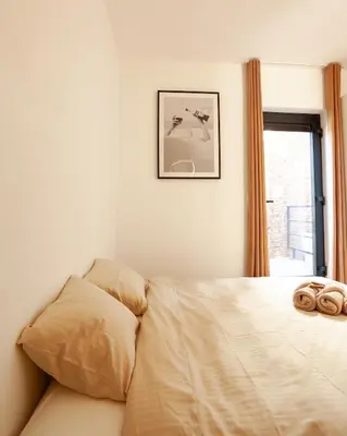 a bedroom with a bed with two towels on it at 1 BR Stylish flat with balcony in Antwerp