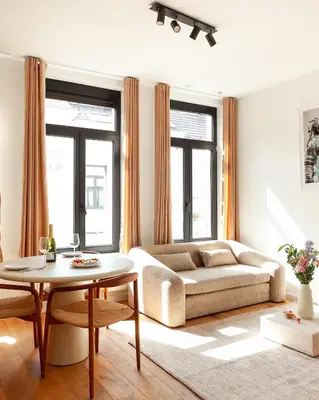 a living room with a couch and a table at 1 BR Stylish flat with balcony in Antwerp