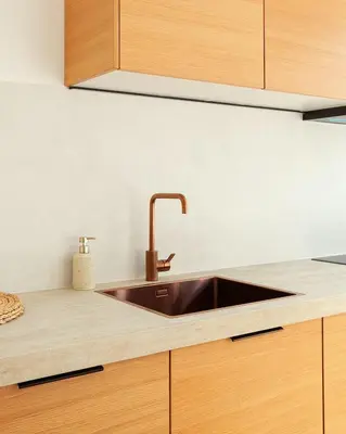 a kitchen with a sink and wooden cabinets at 1 BR Stylish flat with balcony in Antwerp