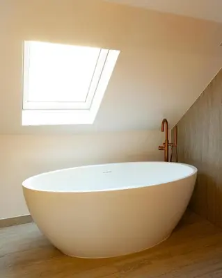 a bath tub in a bathroom with a window at Cozy 1BDR Topfloor duplex flat in Antwerp