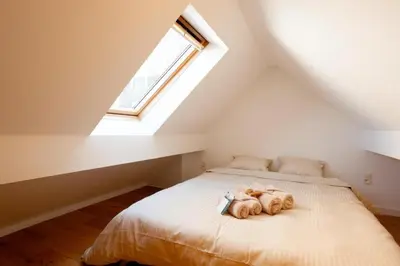 a bedroom with a bed with stuffed animals on it at Cozy 1BDR Topfloor duplex flat in Antwerp