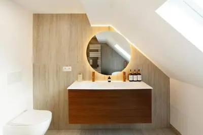 a bathroom with a sink and a mirror at Cozy 1BDR Topfloor duplex flat in Antwerp