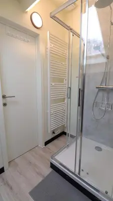 a bathroom with a shower with a glass door at Gite de l'oseraie