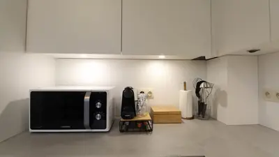 a microwave sitting on a counter in a room at Gite de l'oseraie