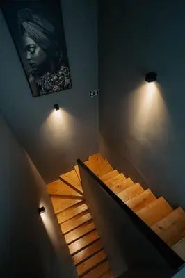 a staircase in a room with lights on the wall at Sunset Penthouse Antwerp in Antwerp