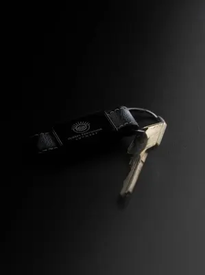 a pair of keys sitting on a black surface at Sunset Penthouse Antwerp in Antwerp