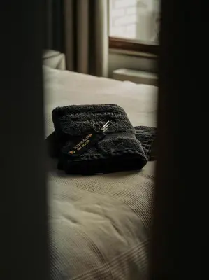a pair of scissors sitting on top of a bed at Sunset Penthouse Antwerp in Antwerp