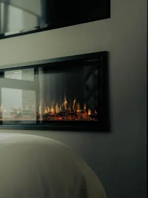 a fire in a fireplace in a room at Sunset Penthouse Antwerp in Antwerp