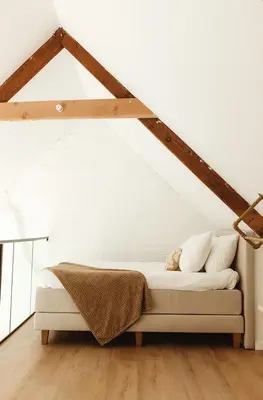a bedroom with a bed in a attic at Studio & Stay Loft in Ghent