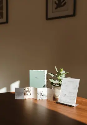 a table with cards on top of a table with a plant at Studio & Stay Loft in Ghent