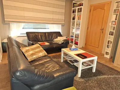 a living room with a leather couch and a coffee table at Villa in Diest nabij het groen in Diest